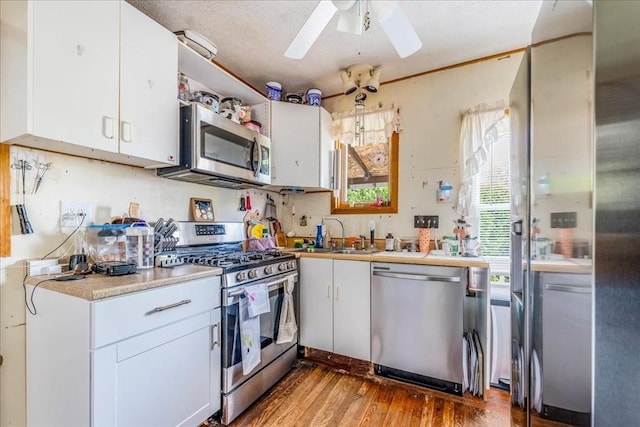 1241 Riverside Ave, Somerset, MA 02726 - kitchen featuring ceiling fan, light wood-style floors, light countertops, white cabinets, and appliances with stainless steel finishes