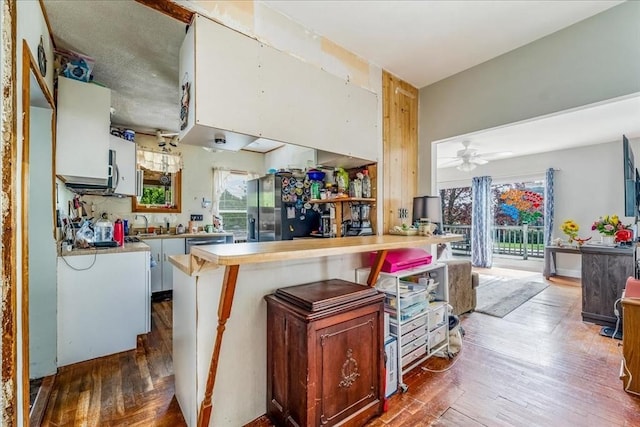 1241 Riverside Ave, Somerset, MA 02726 - kitchen with dark wood-style floors, a wealth of natural light, light countertops, and stainless steel refrigerator with ice dispenser