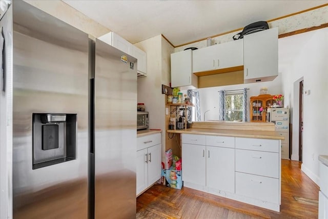 1241 Riverside Ave, Somerset, MA 02726 - kitchen with light countertops, stainless steel fridge with ice dispenser, white cabinets, and a toaster
