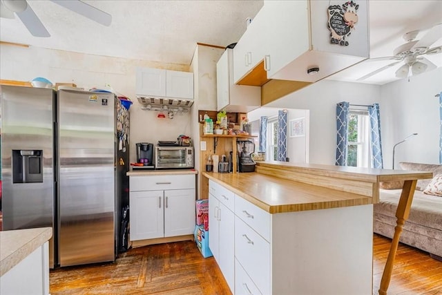 1241 Riverside Ave, Somerset, MA 02726 - kitchen featuring a peninsula, stainless steel fridge, a ceiling fan, and white cabinets