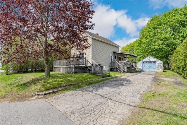 1241 Riverside Ave, Somerset, MA 02726 - view of side of property with aphalt driveway, an outdoor structure, a detached garage, a yard, and stairway