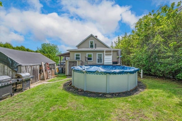 1241 Riverside Ave, Somerset, MA 02726 - rear view of house with a lawn and a covered pool