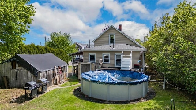 1241 Riverside Ave, Somerset, MA 02726 - rear view of house featuring a covered pool, a chimney, and a lawn