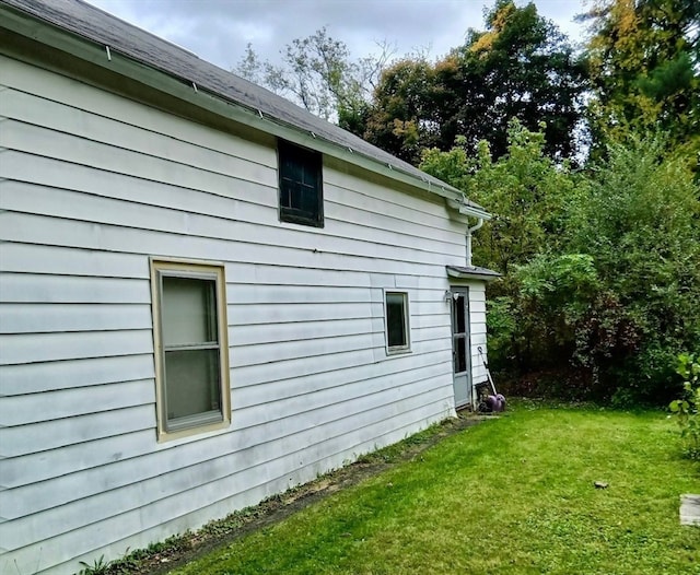 view of side of home featuring a yard