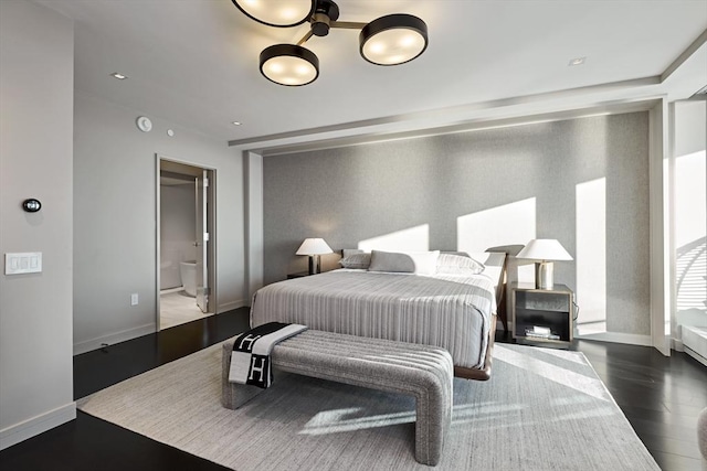 bedroom featuring wood-type flooring and connected bathroom