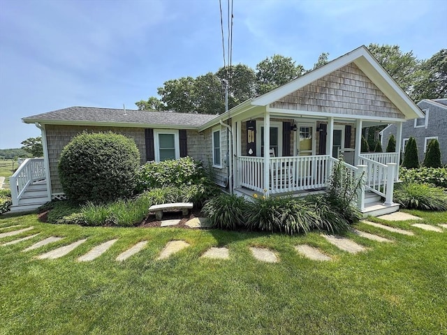 15 Wales Dr, Bourne, MA 02559 - back of property with covered porch and a lawn
