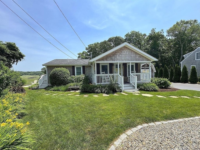 15 Wales Dr, Bourne, MA 02559 - view of front facade with a porch and a front yard