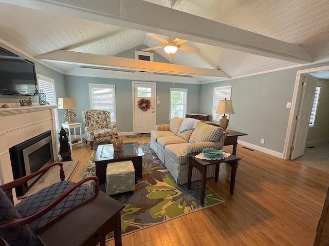 15 Wales Dr, Bourne, MA 02559 - living area with wood finished floors, a fireplace, ceiling fan, and plenty of natural light