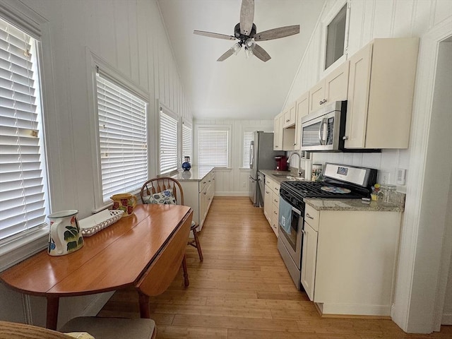 15 Wales Dr, Bourne, MA 02559 - kitchen featuring appliances with stainless steel finishes, vaulted ceiling, light wood-style floors, a ceiling fan, and white cabinetry