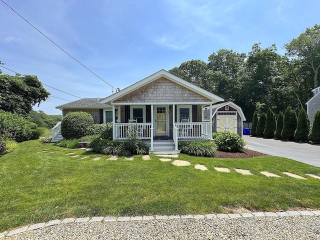 15 Wales Dr, Bourne, MA 02559 - view of front of home featuring covered porch and a front yard