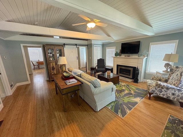 15 Wales Dr, Bourne, MA 02559 - living area featuring a barn door, wood finished floors, a fireplace, and ceiling fan