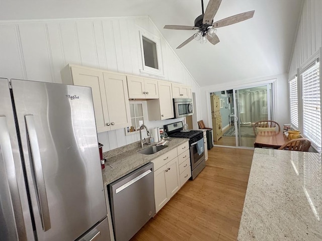 15 Wales Dr, Bourne, MA 02559 - kitchen featuring stainless steel appliances, lofted ceiling, ceiling fan, light wood finished floors, and light stone countertops