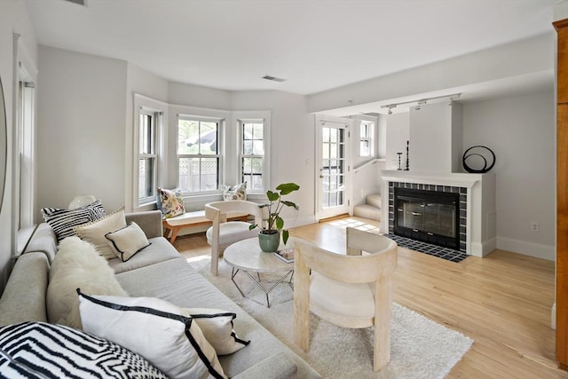 85 Sherman Unit 3, Cambridge, MA 02139 - living area featuring light wood-style flooring and a tiled fireplace