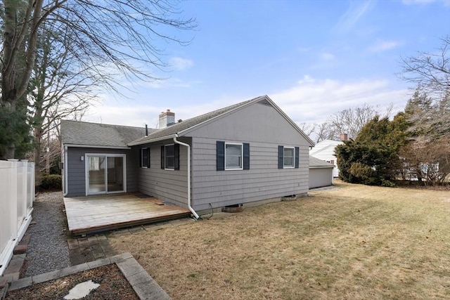 back of house with fence, a yard, a shingled roof, a wooden deck, and a chimney