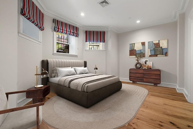 bedroom featuring wood-type flooring and crown molding