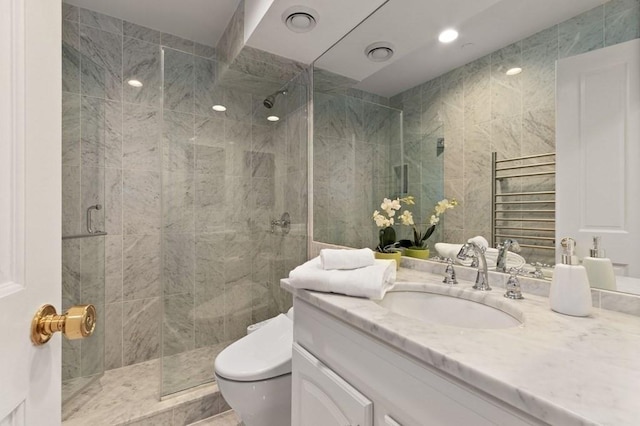 bathroom featuring vanity, an enclosed shower, and toilet