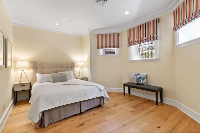 bedroom with light hardwood / wood-style floors and ornamental molding