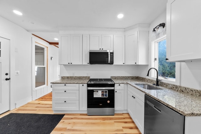 kitchen featuring appliances with stainless steel finishes and white cabinets