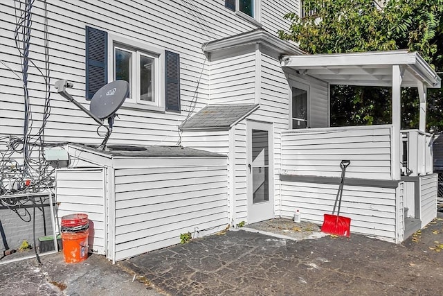 view of property exterior with a patio area