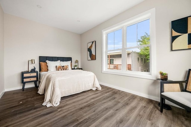 bedroom with dark hardwood / wood-style floors