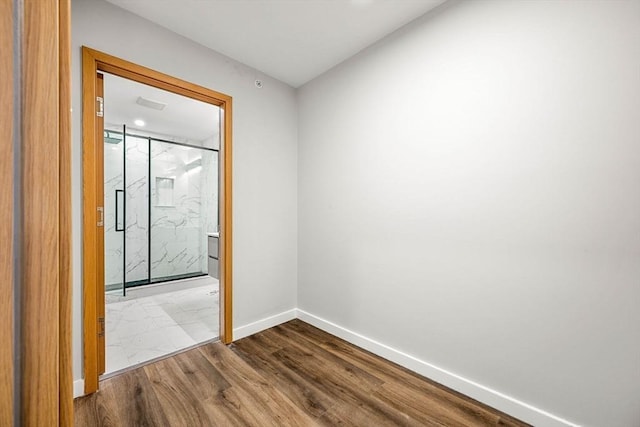 spare room featuring wood-type flooring