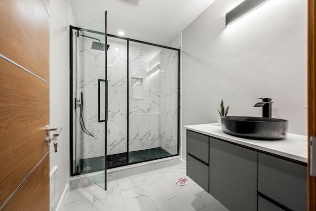 bathroom with walk in shower and vanity