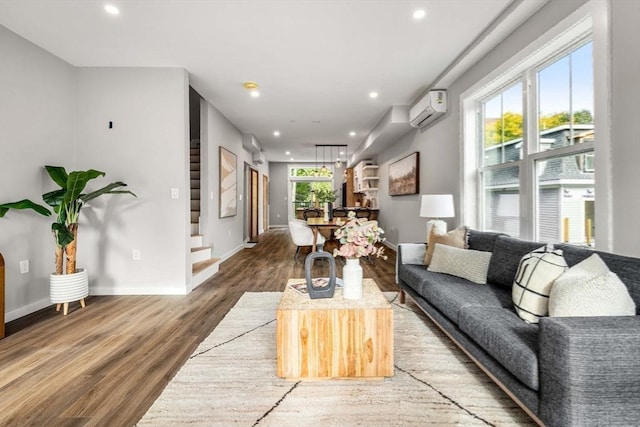 living room with wood-type flooring and a wall mounted AC