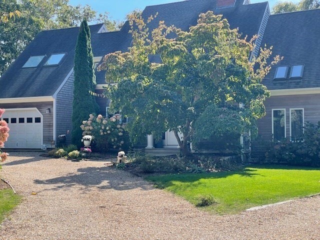 view of property exterior featuring a yard and a garage