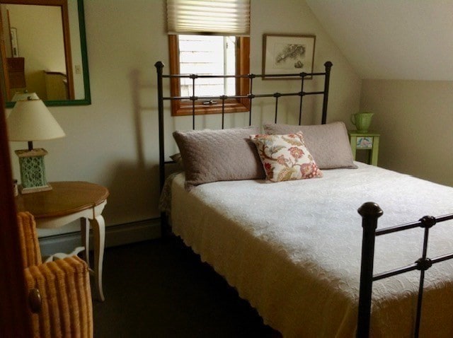 bedroom with carpet and vaulted ceiling