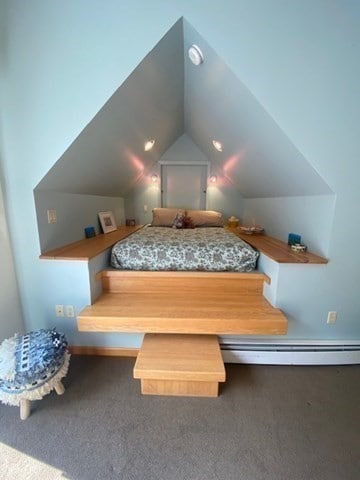 bedroom featuring a baseboard radiator, carpet, and vaulted ceiling