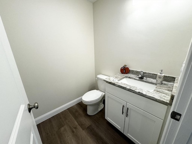 bathroom featuring hardwood / wood-style floors, vanity, and toilet