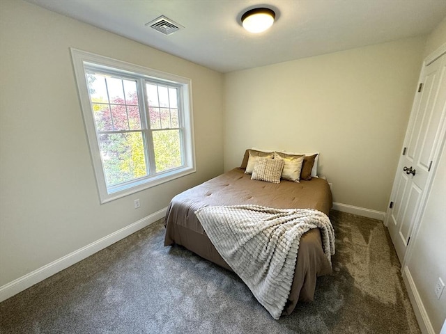 bedroom with dark colored carpet