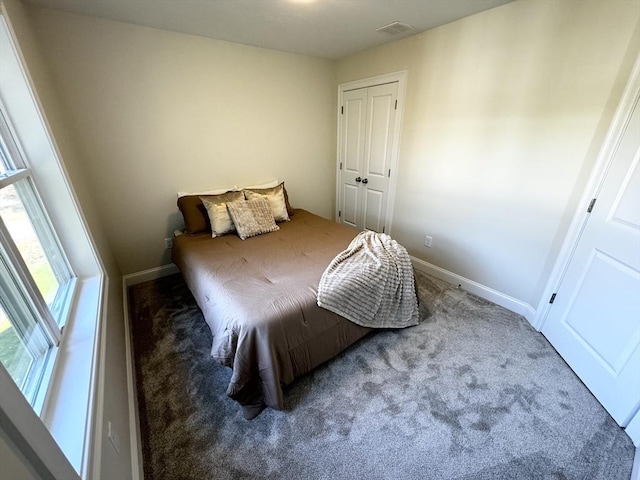 carpeted bedroom with a closet