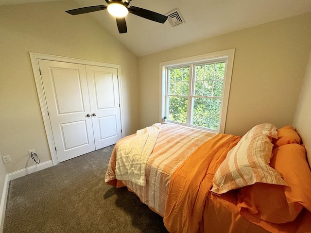 carpeted bedroom with a closet, vaulted ceiling, and ceiling fan