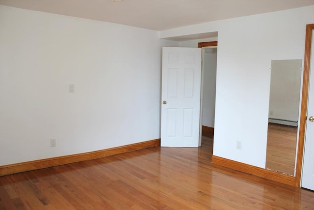 143 Branch St, Lowell, MA 01851 - unfurnished room featuring a baseboard radiator, light wood-style floors, and baseboards