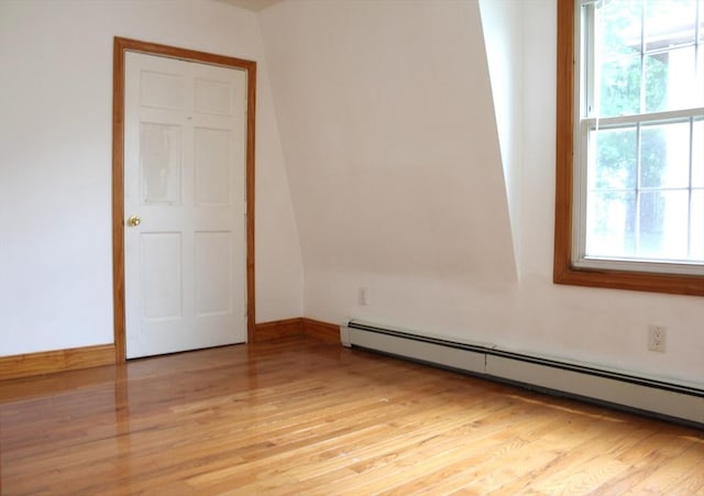 143 Branch St, Lowell, MA 01851 - spare room with a baseboard heating unit, light wood-style floors, and baseboards