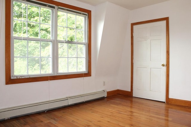 143 Branch St, Lowell, MA 01851 - spare room featuring a baseboard radiator, light wood-type flooring, and baseboards