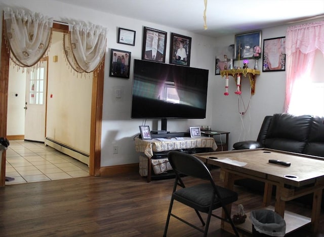 143 Branch St, Lowell, MA 01851 - living area with baseboard heating, wood finished floors, and baseboards