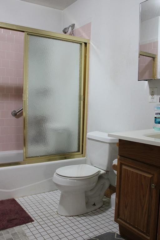 143 Branch St, Lowell, MA 01851 - full bath with toilet, vanity, shower / bath combination with glass door, and tile patterned floors