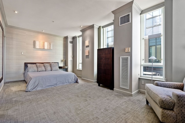 bedroom with light colored carpet, multiple windows, and crown molding