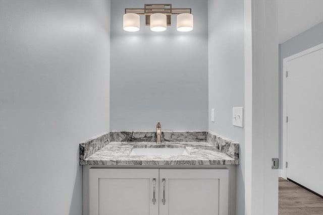 bathroom with hardwood / wood-style flooring and vanity