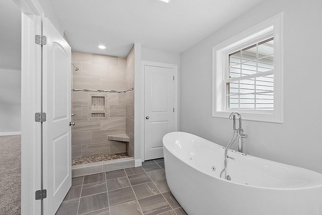 bathroom with tile patterned floors and shower with separate bathtub