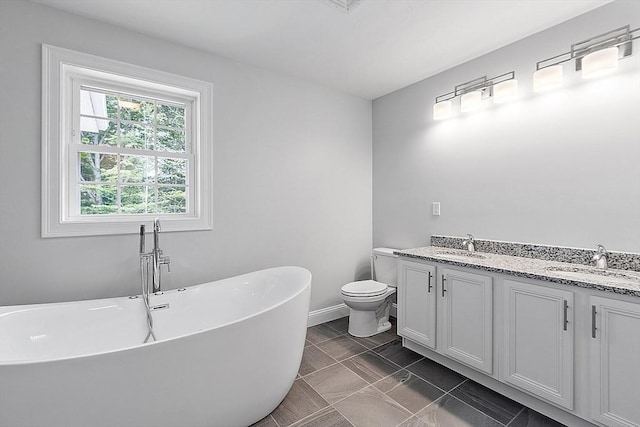 bathroom featuring vanity, a tub, and toilet