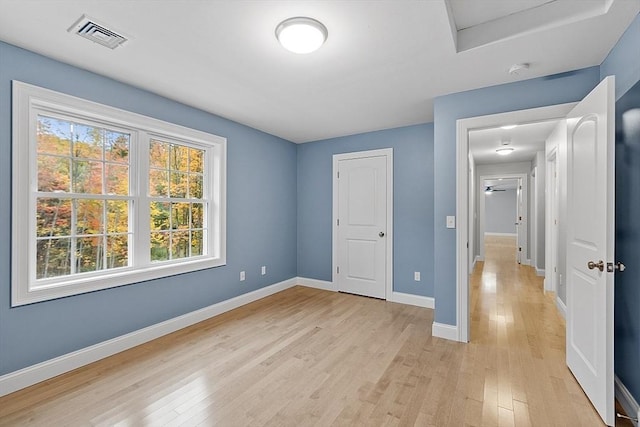 unfurnished bedroom with light wood-type flooring