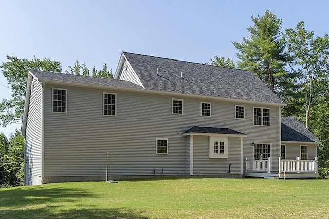 back of property featuring a yard and a deck