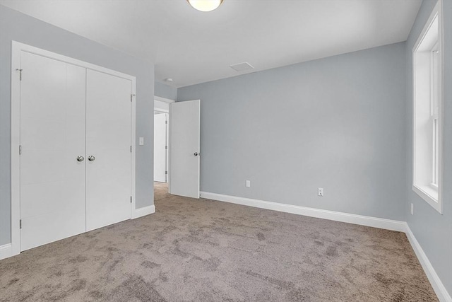 unfurnished bedroom with carpet floors and a closet