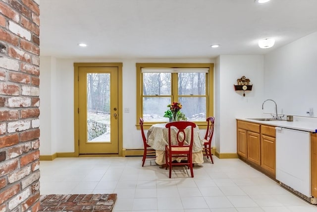 interior space featuring baseboard heating, recessed lighting, a sink, and baseboards