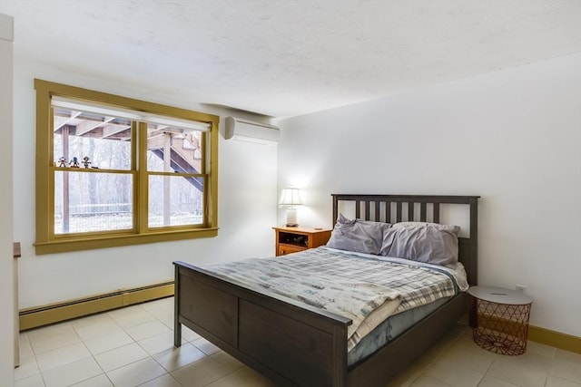 bedroom featuring a baseboard radiator, a wall mounted air conditioner, and baseboards