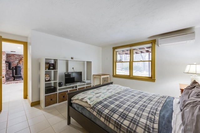 bedroom featuring an AC wall unit and light tile patterned flooring