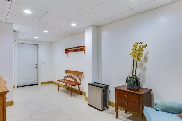 interior space with recessed lighting, a paneled ceiling, and baseboards